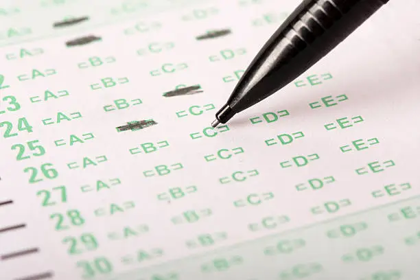 An answer sheet or optical mark recognition sheet with a mechanical pencil about to fill in an answer.