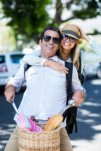 istock Couple riding bicycle on street 594457882