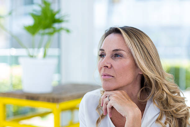 istock Thoughtful mature woman in restaurant 594458100