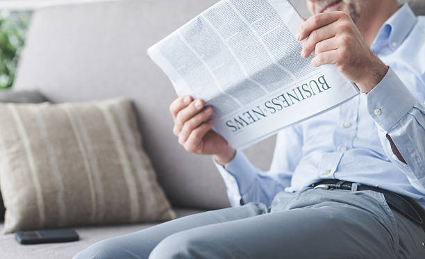 istock Businessman reading news 594460628