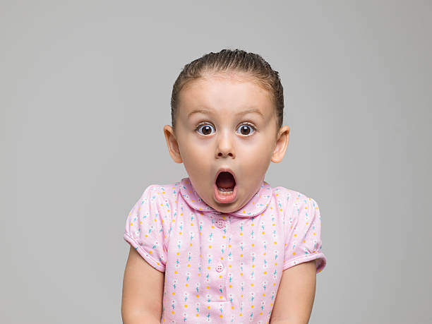 istock Baby girl standing with a shocked face 594460632