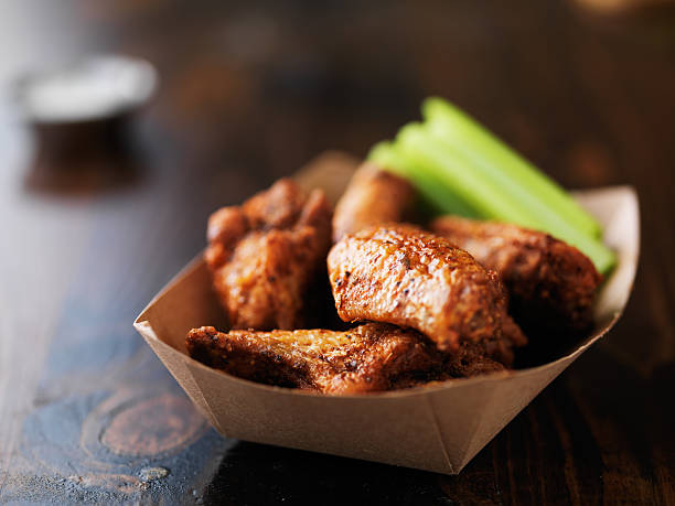 istock barbecue buffalo chicken wings in paper tray 594460644