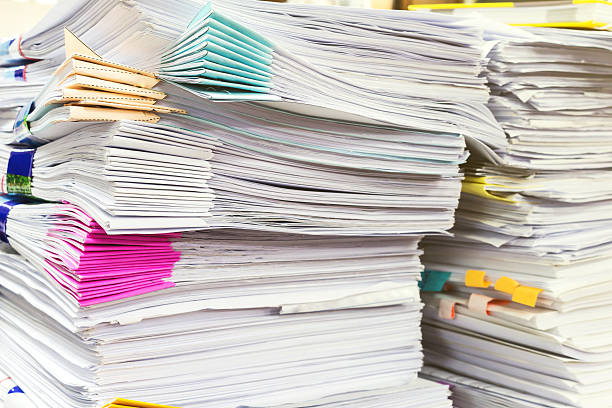 istock pile of document on desk 594461218
