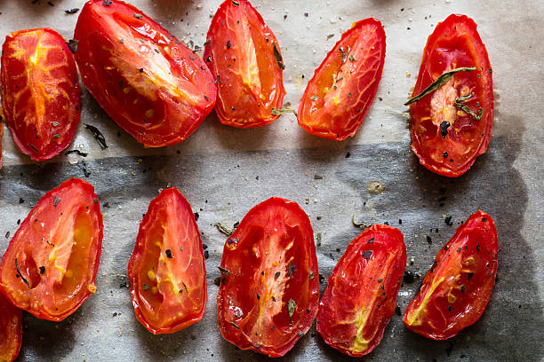 istock Sun dried tomatoes on white baking paper 594462034