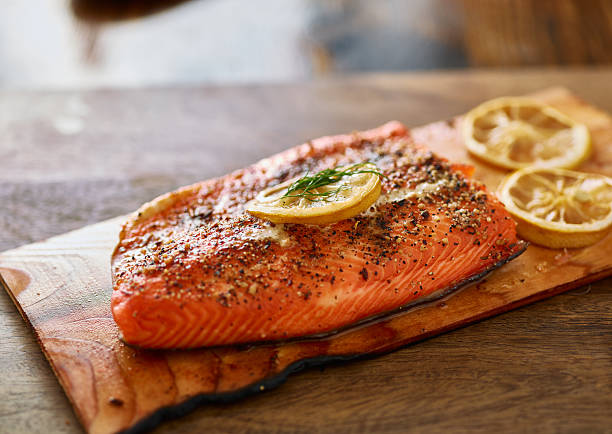 salmón con tablones de cedro cocido con limón y eneldo - prepared fish fish grilled close up fotografías e imágenes de stock