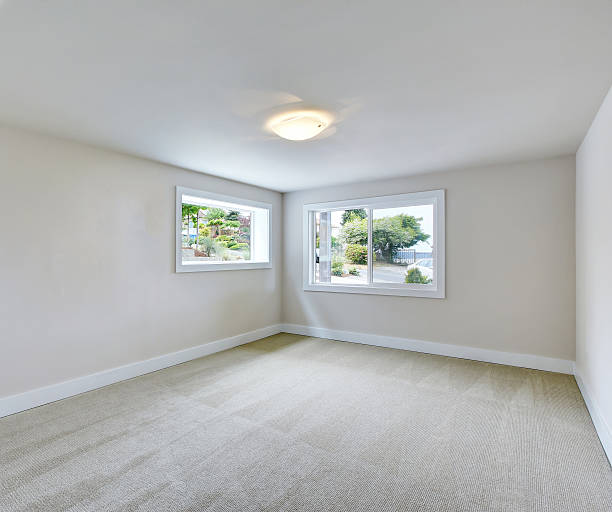 istock Empty room interior in light tones with carpet floor. 594463292