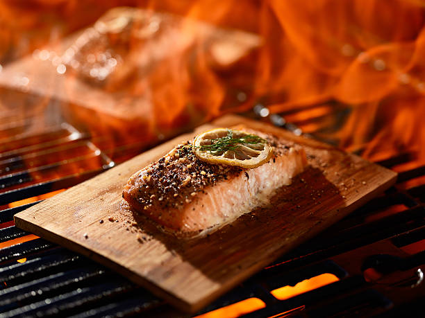 istock grillng salmon fillets on cedar planks 594463314