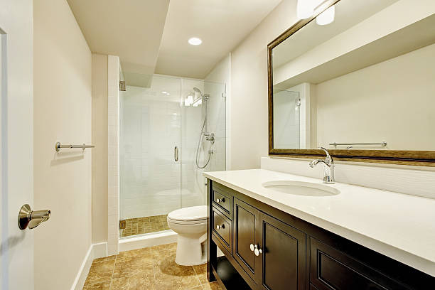 istock Bathroom interior with dark vanity cabinet and big mirror. 594463472
