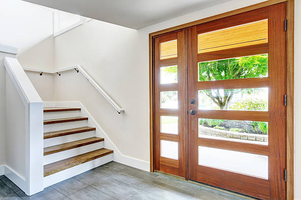 istock Nice entry way to home with carpet staircase ,white interior 594463652