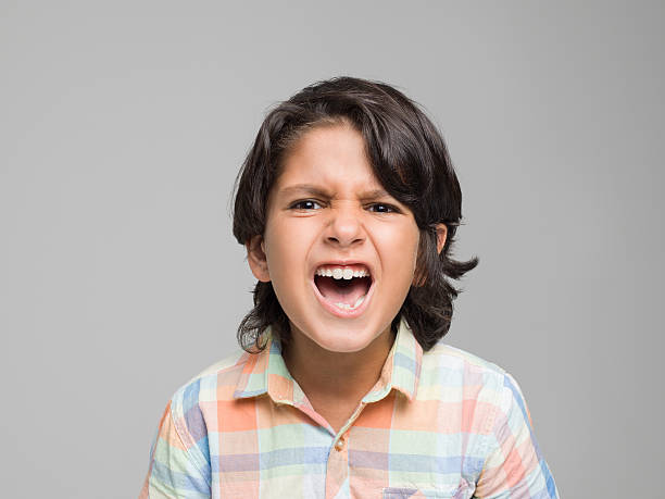 istock Portrait of screaming young boy 594463854