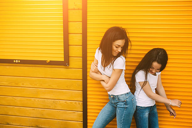 istock mother and her cute daughter, against wall 594463974