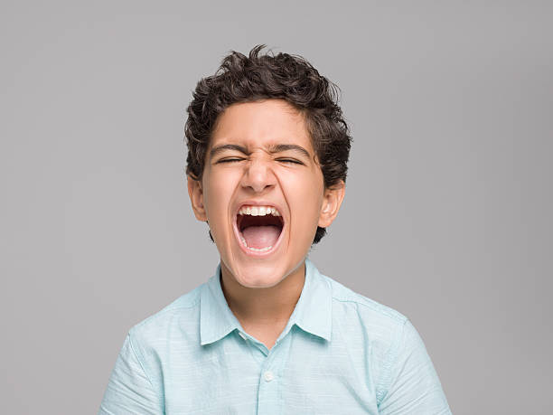 istock Portrait of screaming young boy 594464128