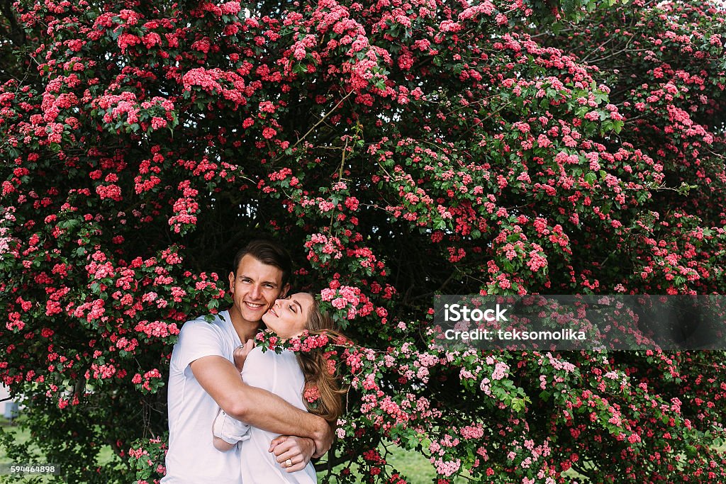 Young happy couple in love outdoors Young happy couple in love outdoors. loving man and woman on a walk in a spring blooming park Adult Stock Photo