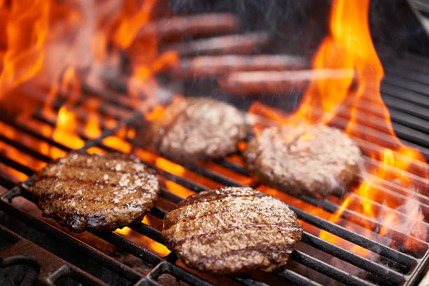 grilling hamburgers and hot dogs - barbecue grill barbecue burger hamburger imagens e fotografias de stock