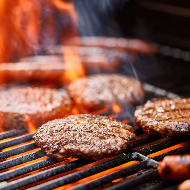 istock flame broiled hamburger patties cooking on grill 594465196