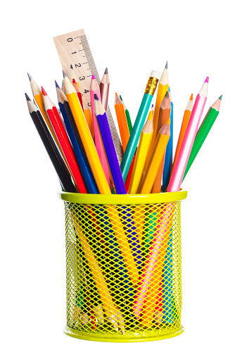 basket with colored pencils on white background