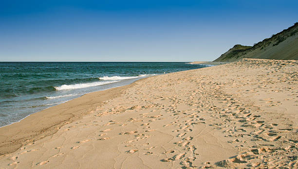 istock Sandy Beach, Footsteps and Dunes, Truro, Cape Cod, Massachusetts, USA. 594465828