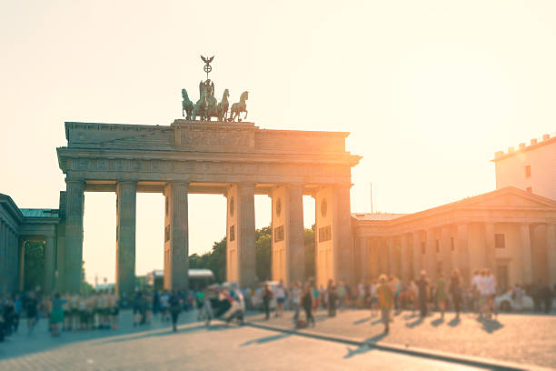 istock summer afternoon with sun backlit at Brandenburger Tor Berlin 594466520