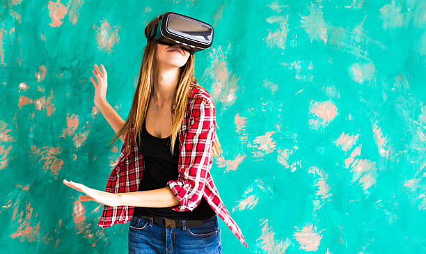 istock girl getting experience using VR-headset glasses of virtual reality 594467844