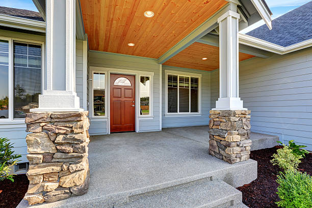 istock Light blue siding house . Porch with stone base columns. 594468010