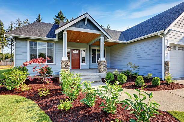 istock Light blue siding house . Porch with stone base columns. 594468324