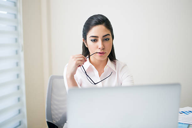 istock Office worker on the computer and holding eyeglasses 594468380