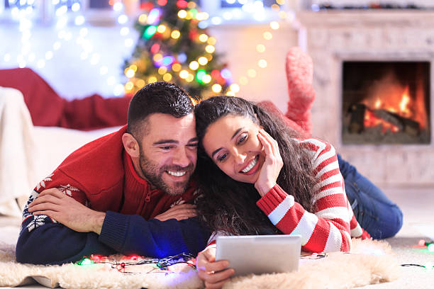 istock Couple lying on ground and using digital tablet at home 594469482