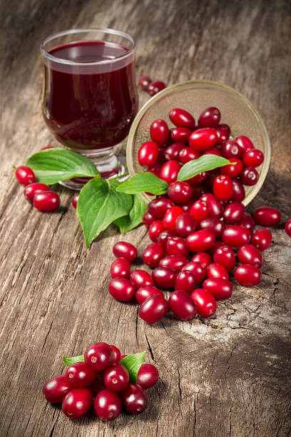 istock Cornel berry juice on wooden table 594469582