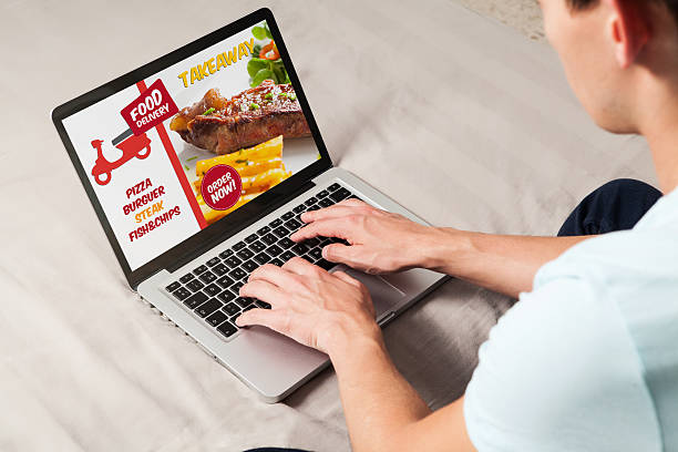 istock Takeaway food delivery website in a laptop computer. 594470386