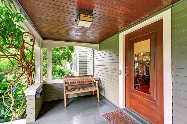 istock Cozy covered porch interior with wooden bench. 594470494