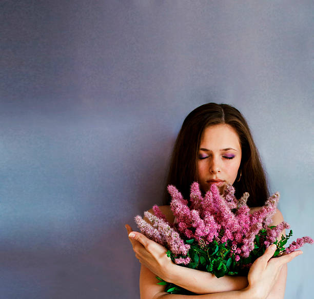 istock Girl and lilacs 594471970