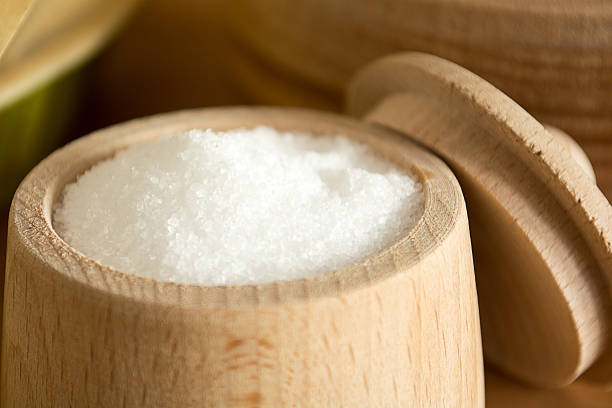 istock Small cup of salt on the kitchen table 594472020