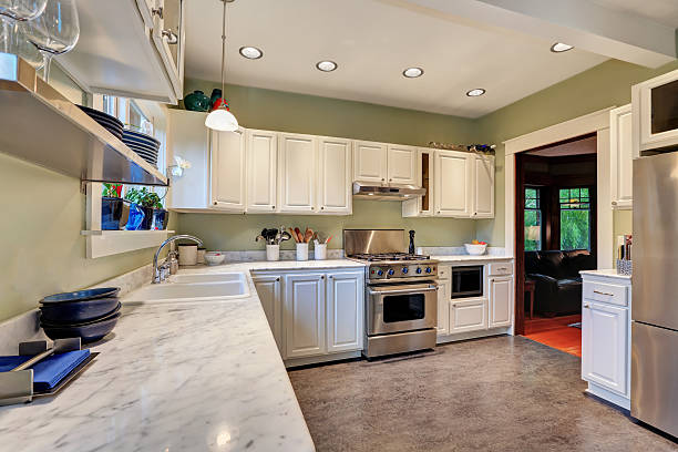 istock Bright kitchen interior with white cabinets and marble counter top 594472528