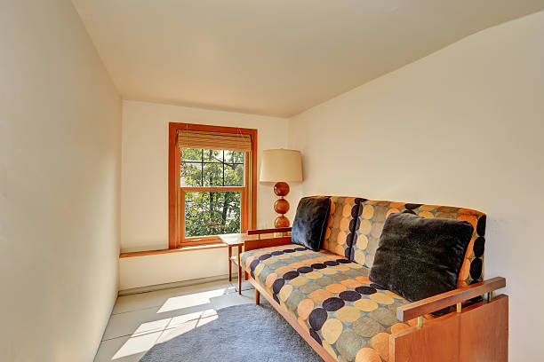 istock Small upstairs room with bright orange and black sofa 594473502