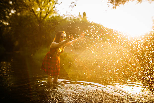 istock Girl having fun in the river 594473600