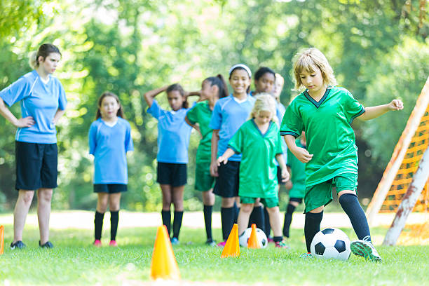 istock Young girls soccer team runs through drills 594473692