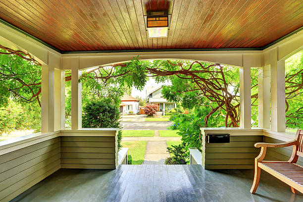 istock Cozy covered porch interior with wooden bench. 594473838