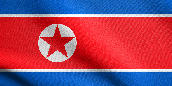 Flag of North Korea, Democratic Peoples Republic of Korea waving in the wind with detailed fabric texture. North Korean, DPRK, national flag.