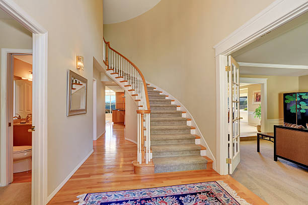 istock Bright beige hallway interior with carpet staircase 594474664