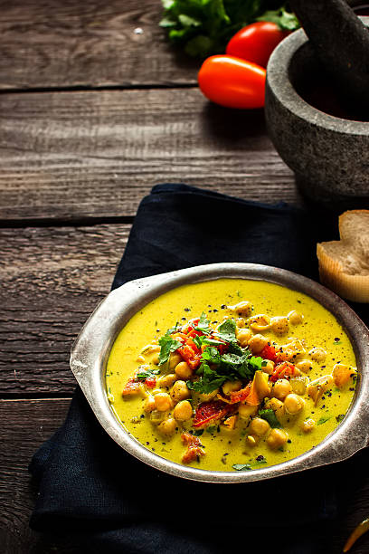istock Soup in mug with chick-pea and spices on blue background. 594475316