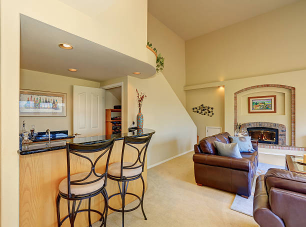 istock Great half living room with home bar and stools 594475424