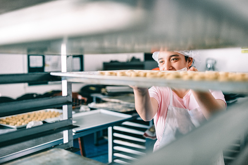 Volunteer with intelectual disability working at a Bakery Workshop