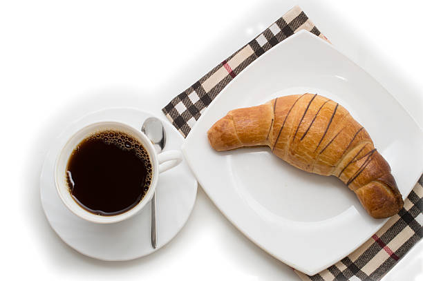 istock cup of coffee with croissant on white background 594476178