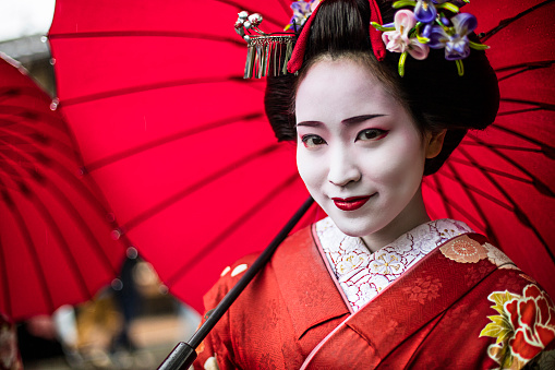 Portrait of a beautiful Maiko  in the streets of Kyoto - Japan.