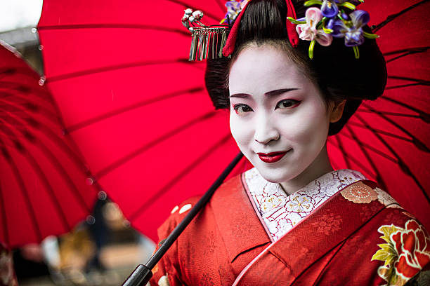 Portrait of a beautiful Maiko Portrait of a beautiful Maiko  in the streets of Kyoto - Japan. behavior femininity outdoors horizontal stock pictures, royalty-free photos & images