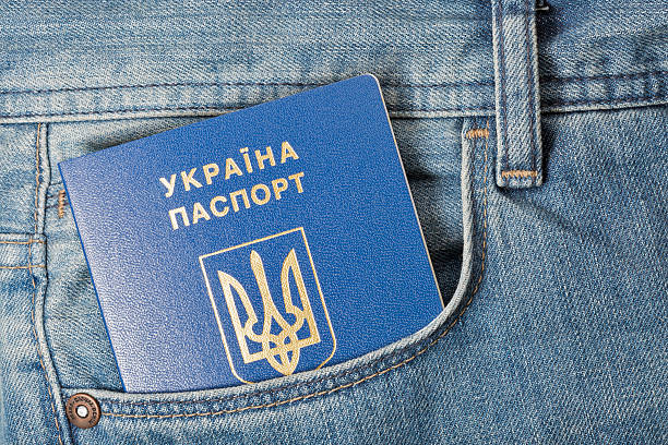 blue ukrainian passport in pocket of jeans closeup a blue ukrainian passport in front pocket of blue jeans closeup jeans denim passport pocket stock pictures, royalty-free photos & images