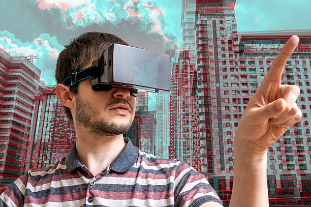 istock Young man wearing virtual reality headset. 3D simulation of city. 594476964