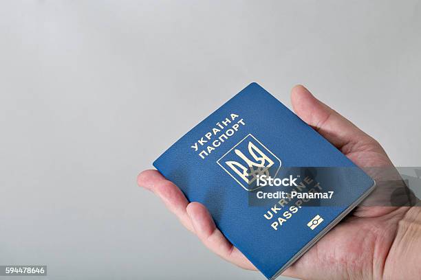 Hand Holding Ukrainian Biometric Passport On White Background Stock Photo - Download Image Now