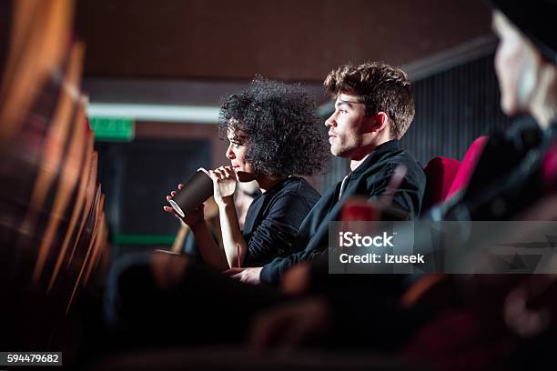 Young People In The Movie Theater Stock Photo - Download Image Now - Adult, Afro Hairstyle, Arts Culture and Entertainment