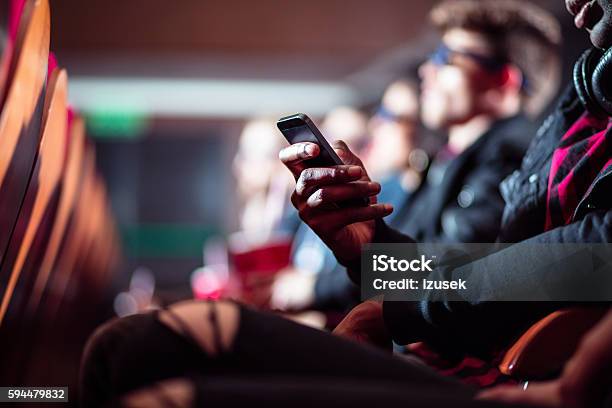 People In The Movie Theater Close Up Of Mobile Stock Photo - Download Image Now - Movie Theater, Audience, Telephone